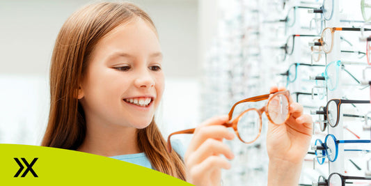 Young girl trying on glasses.