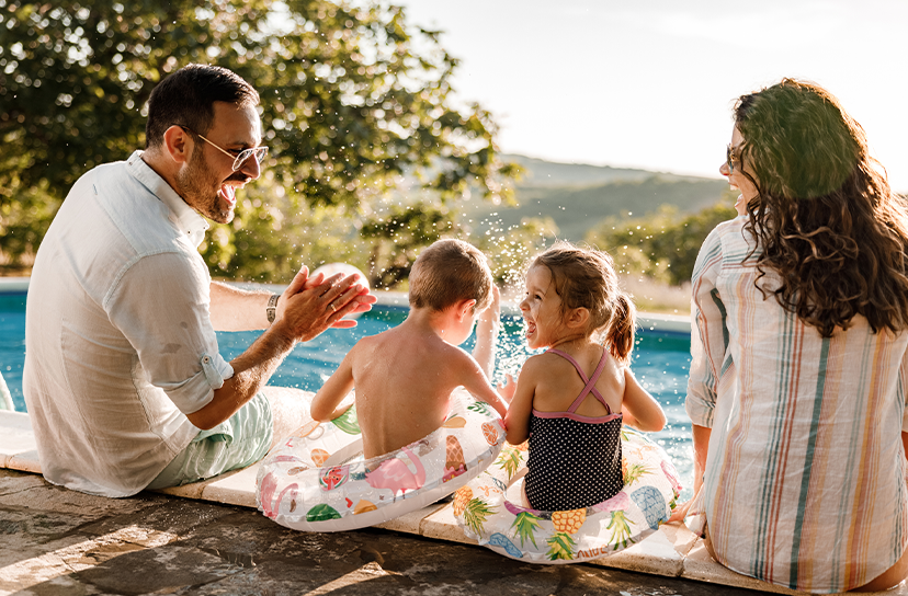 Family by a pool with a scenic background